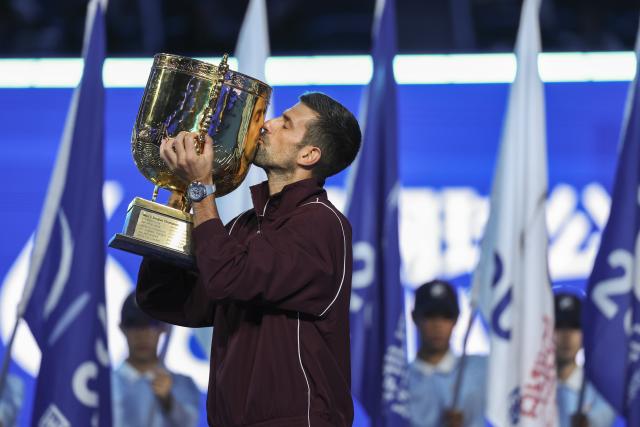 (261006) -- BEIJING, Oct. 6, 2026 (Xinhua) -- Novak Djokovic of Serbia kisses the champion trophy during the awarding ceremony for the men's singles final at 2026 China Open tennis tournament in Beijing, China, Oct. 6, 2026. (Xinhua/Bai Xuefei)