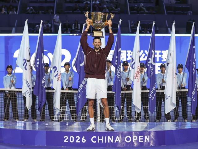 (261006) -- BEIJING, Oct. 6, 2026 (Xinhua) -- Novak Djokovic of Serbia holds up the champion trophy during the awarding ceremony for the men's singles final at 2026 China Open tennis tournament in Beijing, China, Oct. 6, 2026. (Xinhua/Bai Xuefei)
