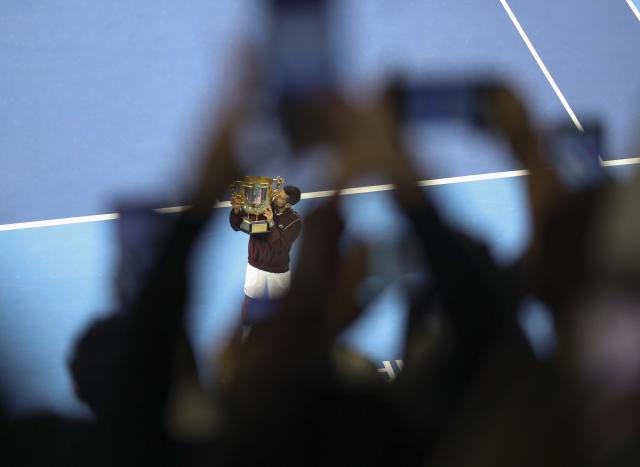 (261006) -- BEIJING, Oct. 6, 2026 (Xinhua) -- Winner Novak Djokovic kisses the champion trophy during the awarding ceremony for the men's singles final at 2026 China Open tennis tournament in Beijing, China, Oct. 6, 2026. (Photo by Ma Zihan/Xinhua)