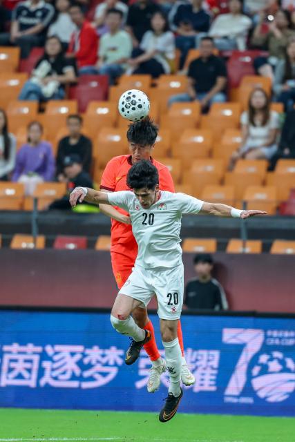 (261006) -- CHONGQING, Oct. 6, 2026 (Xinhua) -- Liu Yang (top) of China and Alijon Karomatullozoda of Tajikistan head for the ball during the CFA Team China International Football Competitions Chongqing 2026 between China and Tajikistan in Chongqing, Oct. 6, 2026. (Xinhua/Huang Wei)