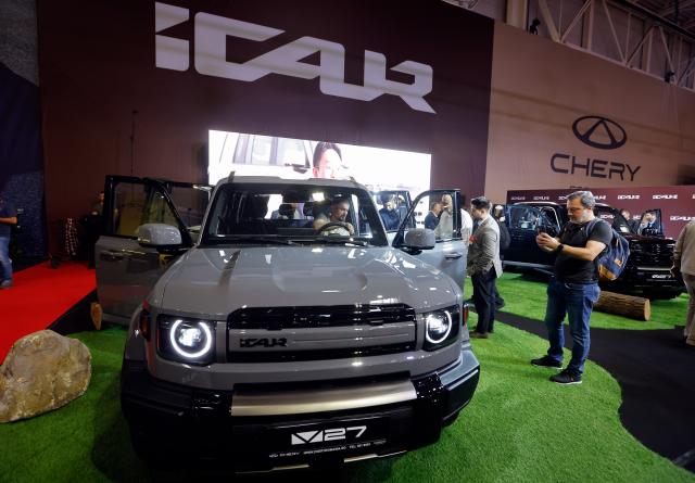 (261006) -- BUCHAREST, Oct. 6, 2026 (Xinhua) -- Visitors look at a car model produced by Chinese producer Chery during the first day of Bucharest Auto Show & Accessories in Bucharest, Romania, Oct. 6, 2026. (Photo by Cristian Cristel/Xinhua)