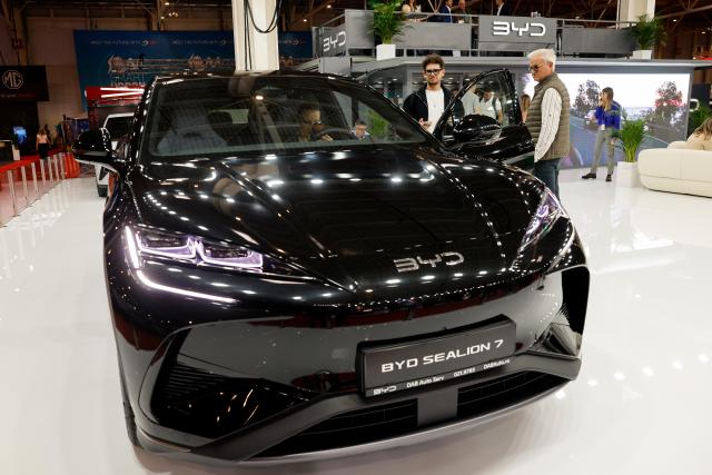(261006) -- BUCHAREST, Oct. 6, 2026 (Xinhua) -- Visitors look at a car model produced by Chinese producer BYD during the first day of Bucharest Auto Show & Accessories in Bucharest, Romania, Oct. 6, 2026. (Photo by Cristian Cristel/Xinhua)