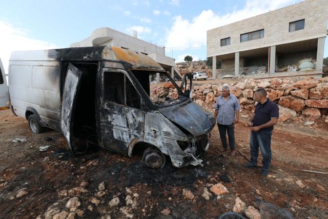 (261006) -- NABLUS, Oct. 6, 2026 (Xinhua) -- Palestinians inspect a vehicle burnt by Israeli settlers in the village of Aqraba, south of Nablus, in the West Bank, Oct. 6, 2026. (Photo by Nidal Eshtayeh/Xinhua)