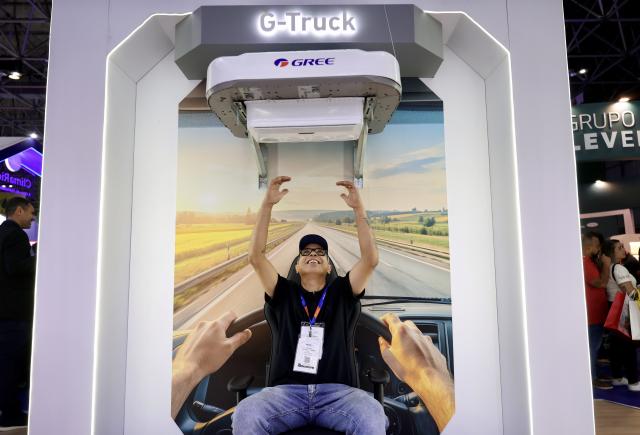 (261007) -- RIO DE JANEIRO, Oct. 7, 2026 (Xinhua) -- A visitor tries an air conditioner of Gree during the FEBRAVA Rio at the Riocentro convention and event center in Rio de Janeiro, Brazil, Oct. 6, 2026. The three-day FEBRAVA Rio (Portuguese short for International Fair of Refrigeration, Air Conditioning, Ventilation, Heating, Air and Water Treatment) kicked off here on Tuesday. Some Chinese brands showcased their latest products during the fair, drawing great attention from visitors. (Xinhua/Jin Haoyuan)