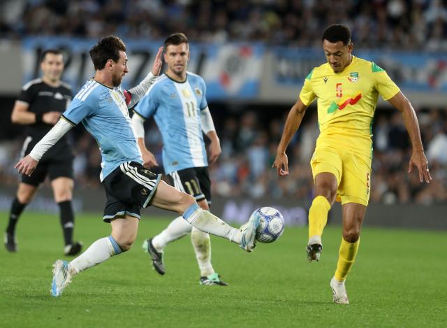 (261007) -- BUENOS AIRES, Oct. 7, 2026 (Xinhua) -- Lionel Messi (front L) of Argentina vies for the ball with Yohan Roche of Benin during a football friendly match between Argentina and Benin at the Monumental Stadium in Buenos Aires, capital of Argentina, on Oct. 6, 2026. The match marked Lionel Messi's final appearance for the Argentina national football team. (Photo by Martin Zabala/Xinhua)