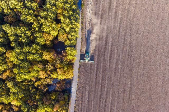 (261007) -- BEIJING, Oct. 7, 2026 (Xinhua) -- An aerial drone photo taken on Oct. 6, 2026 shows a harvester working in a soybean field of a farm under Beidahuang Group in northeast China's Heilongjiang Province. China's top grain producer Heilongjiang Province has witnessed a bountiful harvest during the National Day holiday. (Photo by Liu Dapeng/Xinhua)