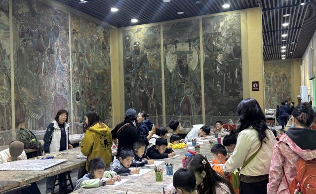 (261007) -- BEIJING, Oct. 7, 2026 (Xinhua) -- Visitors are seen during a study tour for mural copying at the Yongle Palace scenic area in Ruicheng, north China's Shanxi Province, Oct. 2, 2026. (Photo by Guo Song/Xinhua)