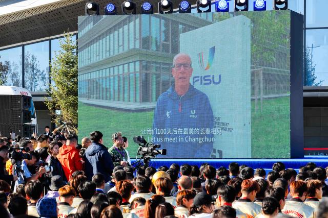 (261007) -- CHANGCHUN, Oct. 7, 2026 (Xinhua) -- Leonz Eder, president of FISU, speaks in a video at the 100-day countdown event for the Changchun 2027 Winter Universiade in Changchun, northeast China's Jilin Province, Oct. 7, 2026. The medals, torch, uniforms and equipment for the Changchun 2027 Winter Universiade were unveiled on Wednesday at a 100-day countdown event held at the Changchun International Aviation Expo City. (Xinhua/Xu Chang)