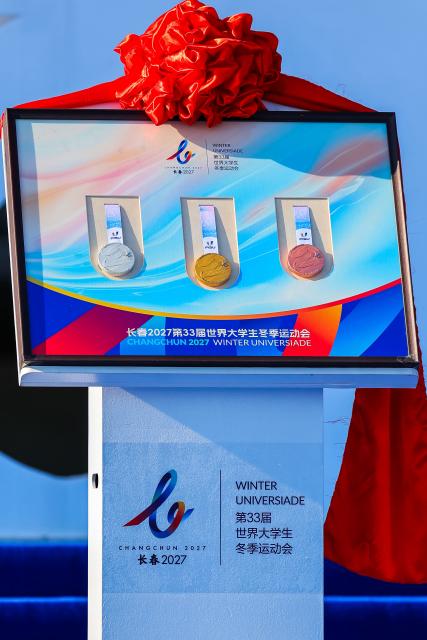 (261007) -- CHANGCHUN, Oct. 7, 2026 (Xinhua) -- The medals are unveiled at the 100-day countdown event for the Changchun 2027 Winter Universiade in Changchun, northeast China's Jilin Province, Oct. 7, 2026. The medals, torch, uniforms and equipment for the Changchun 2027 Winter Universiade were unveiled on Wednesday at a 100-day countdown event held at the Changchun International Aviation Expo City. (Xinhua/Xu Chang)