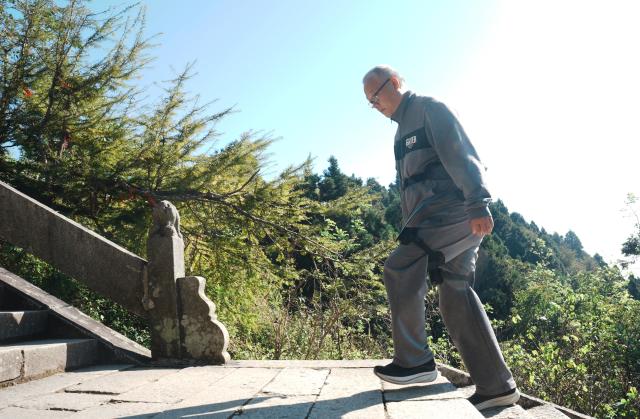 (261007) -- BEIJING, Oct. 7, 2026 (Xinhua) -- A tourist wearing an exoskeleton robot hikes at the Hengshan Mountain scenic area in Hengyang City, central China's Hunan Province, Oct. 6, 2026. Advanced technologies such as exoskeleton devices, AI-powered glasses and robots have enabled diverse and dazzling experiences at tourist destinations across China during the National Day holiday. (Photo by Cao Zhengping/Xinhua)