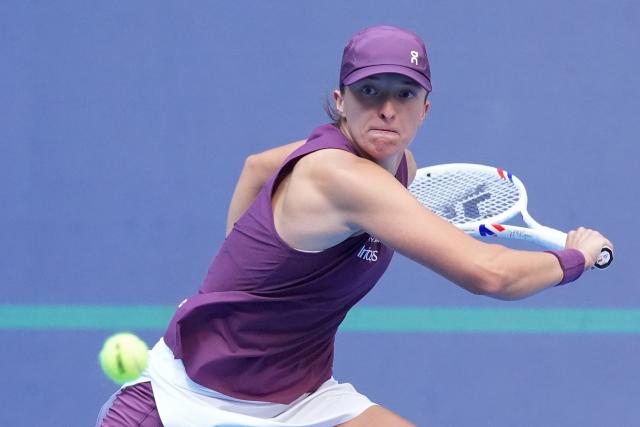 (261007) -- BEIJING, Oct. 7, 2026 (Xinhua) -- Iga Swiatek hits a return during the women's singles fourth round match between Iga Swiatek of Poland and Iva Jovic of the United States at 2026 China Open tennis tournament in Beijing, China, Oct. 7, 2026. (Xinhua/Ju Huanzong)