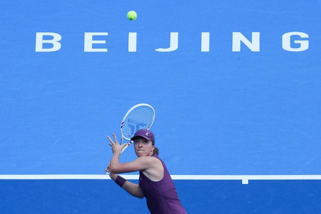 (261007) -- BEIJING, Oct. 7, 2026 (Xinhua) -- Iga Swiatek hits a return during the women's singles fourth round match between Iga Swiatek of Poland and Iva Jovic of the United States at 2026 China Open tennis tournament in Beijing, China, Oct. 7, 2026. (Xinhua/Ju Huanzong)