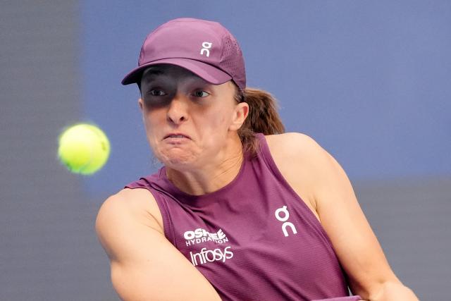 (261007) -- BEIJING, Oct. 7, 2026 (Xinhua) -- Iga Swiatek hits a return during the women's singles fourth round match between Iga Swiatek of Poland and Iva Jovic of the United States at 2026 China Open tennis tournament in Beijing, China, Oct. 7, 2026. (Xinhua/Ju Huanzong)