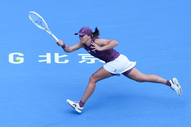 (261007) -- BEIJING, Oct. 7, 2026 (Xinhua) -- Iga Swiatek hits a return during the women's singles fourth round match between Iga Swiatek of Poland and Iva Jovic of the United States at 2026 China Open tennis tournament in Beijing, China, Oct. 7, 2026. (Xinhua/Ju Huanzong)