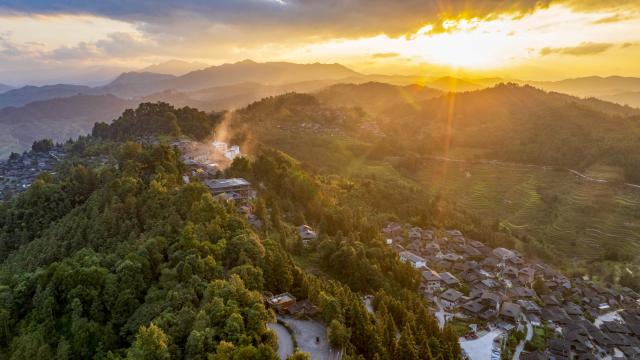 (261007) -- CONGJIANG, Oct. 7, 2026 (Xinhua) -- An aerial drone photo taken on Sept. 28, 2026 shows a sunset view of the Basha Village in Congjiang County of Qiandongnan Miao and Dong Autonomous Prefecture, southwest China's Guizhou Province. Located seven kilometers away from the county seat of Congjiang, Basha Village has attracted an increasing number of overseas tourists with its charming scenery and simple folk customs recently. 
   Consisting of five hamlets and inhabited by the Miao people, the village was included in the first batch of China's traditional villages in 2012. Riding the viral "Chinamaxxing" wave on social media, foreign tourists have come here to experience ancient ways of life and profound cultural heritage. 
   Data from the National Immigration Administration shows that China recorded 22.91 million inbound foreign visits in the first half of this year, up 20.4 percent year on year. (Photo by Wu Dejun/Xinhua)