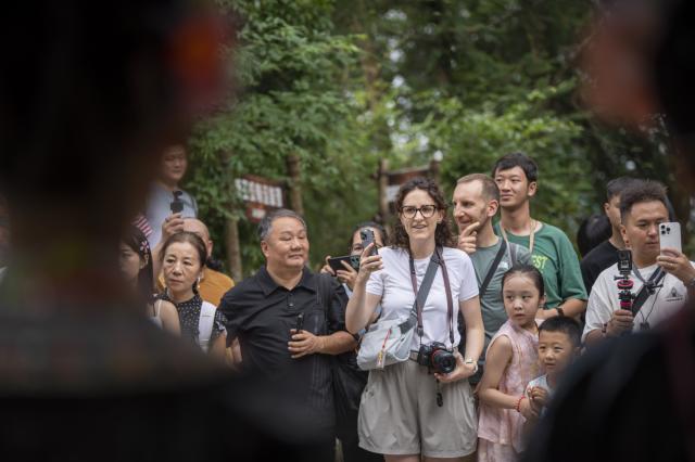 (261007) -- CONGJIANG, Oct. 7, 2026 (Xinhua) -- Visitors attend a welcome ceremony at Basha Village in Congjiang County of Qiandongnan Miao and Dong Autonomous Prefecture, southwest China's Guizhou Province, Aug. 24, 2026. Located seven kilometers away from the county seat of Congjiang, Basha Village has attracted an increasing number of overseas tourists with its charming scenery and simple folk customs recently. 
   Consisting of five hamlets and inhabited by the Miao people, the village was included in the first batch of China's traditional villages in 2012. Riding the viral "Chinamaxxing" wave on social media, foreign tourists have come here to experience ancient ways of life and profound cultural heritage. 
   Data from the National Immigration Administration shows that China recorded 22.91 million inbound foreign visits in the first half of this year, up 20.4 percent year on year. (Photo by Wu Dejun/Xinhua)