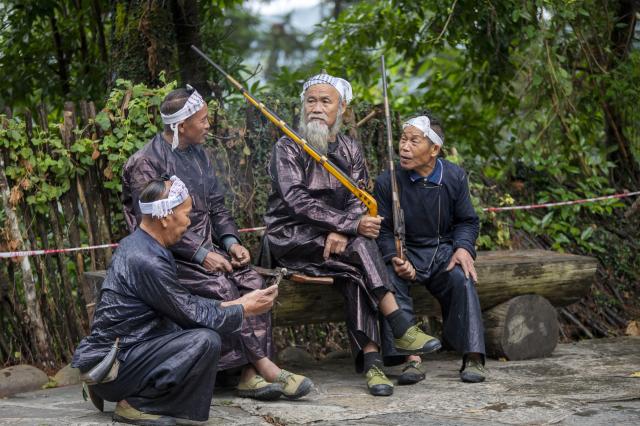 (261007) -- CONGJIANG, Oct. 7, 2026 (Xinhua) -- Villagers wait to welcome visitors at Basha Village in Congjiang County of Qiandongnan Miao and Dong Autonomous Prefecture, southwest China's Guizhou Province, Oct. 2, 2026. Located seven kilometers away from the county seat of Congjiang, Basha Village has attracted an increasing number of overseas tourists with its charming scenery and simple folk customs recently. 
   Consisting of five hamlets and inhabited by the Miao people, the village was included in the first batch of China's traditional villages in 2012. Riding the viral "Chinamaxxing" wave on social media, foreign tourists have come here to experience ancient ways of life and profound cultural heritage. 
   Data from the National Immigration Administration shows that China recorded 22.91 million inbound foreign visits in the first half of this year, up 20.4 percent year on year. (Photo by Wu Dejun/Xinhua)