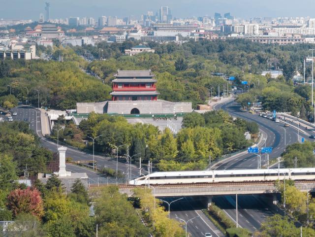 (261007) -- BEIJING, Oct. 7, 2026 (Xinhua) -- A bullet train runs past Yongdingmen Gate in Beijing, capital of China, Oct. 7, 2026. As the National Day holiday is drawing to a close, return travel flows increase across the country. (Xinhua/Xing Guangli)