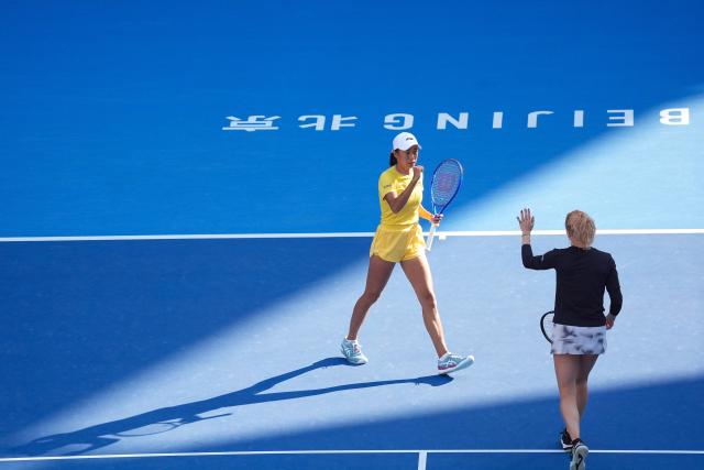(261007) -- BEIJING, Oct. 7, 2026 (Xinhua) -- Katerina Siniakova/Zhang Shuai (L) celebrate during the women's doubles round of 16 match between Katerina Siniakova(the Cezch Republic)/Zhang Shuai(China) and Nikola Bartunkova(the Cezch Republic)/Maja Chwalinska(Poland) at 2026 China Open tennis tournament in Beijing, China, Oct. 7, 2026. (Xinhua/Ju Huanzong)