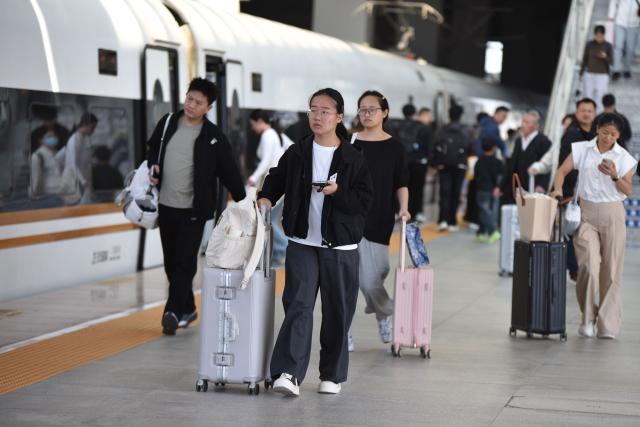 (261007) -- BEIJING, Oct. 7, 2026 (Xinhua) -- Passengers are seen at Fuyang West Railway Station in Fuyang, east China's Anhui Province, Oct. 7, 2026. As the National Day holiday is drawing to a close, return travel flows increase across the country. (Photo by Lu Qijian/Xinhua)