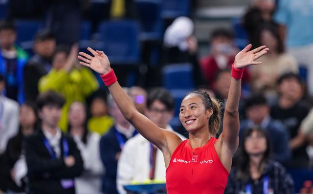 (261007) -- BEIJING, Oct. 7, 2026 (Xinhua) -- Zheng Qinwen of China waves to spectators after winning the women's singles fourth round match between Zheng Qinwen of China and Alina Charaeva of Armenia at 2026 China Open tennis tournament in Beijing, China, Oct. 7, 2026. (Xinhua/Sun Fei)