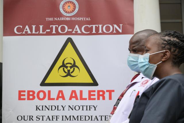 (261007) -- NAIROBI, Oct. 7, 2026 (Xinhua) -- Medical workers walk past an Ebola alert poster at Nairobi Hospital in Nairobi, Kenya, Oct. 7, 2026. Kenya on Tuesday confirmed its first imported case of Bundibugyo Ebola virus disease, one day after a man died in a Nairobi hospital, the country's health authorities said. (Xinhua/Yang Guang)