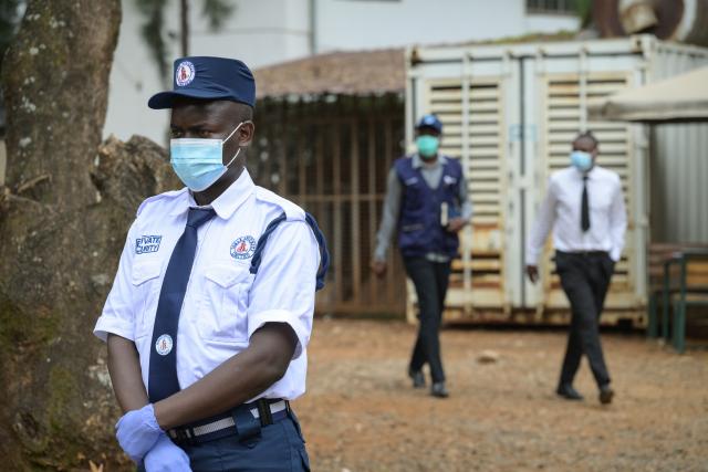 (261007) -- NAIROBI, Oct. 7, 2026 (Xinhua) -- A security guard and staff members wearing face masks are seen at Nairobi Hospital in Nairobi, Kenya, Oct. 7, 2026. Kenya on Tuesday confirmed its first imported case of Bundibugyo Ebola virus disease, one day after a man died in a Nairobi hospital, the country's health authorities said. (Xinhua/Yang Guang)