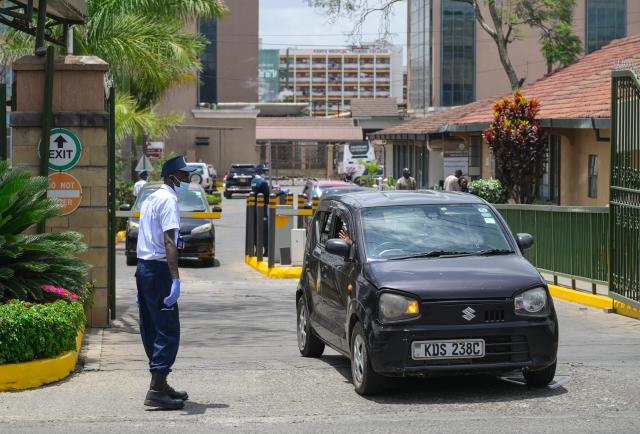 (261007) -- NAIROBI, Oct. 7, 2026 (Xinhua) -- A security guard wearing a face mask and gloves inspects vehicles at the entrance of Nairobi Hospital in Nairobi, Kenya, Oct. 7, 2026. Kenya on Tuesday confirmed its first imported case of Bundibugyo Ebola virus disease, one day after a man died in a Nairobi hospital, the country's health authorities said. (Xinhua/Yang Guang)