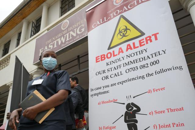 (261007) -- NAIROBI, Oct. 7, 2026 (Xinhua) -- A nurse walks past an Ebola alert poster at Nairobi Hospital in Nairobi, Kenya, Oct. 7, 2026. Kenya on Tuesday confirmed its first imported case of Bundibugyo Ebola virus disease, one day after a man died in a Nairobi hospital, the country's health authorities said. (Xinhua/Yang Guang)