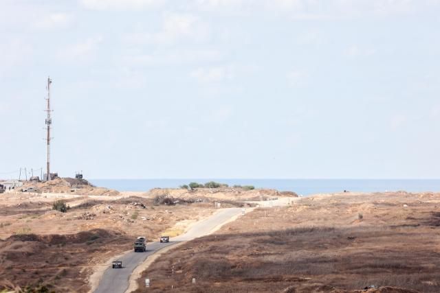 (261007) -- TEL AVIV, Oct. 7, 2026 (Xinhua) -- This photo taken from an area near Israel's southern border on Oct. 6, 2026 shows Israeli military vehicles moving inside the Gaza Strip. The latest round of Gaza conflict marks its third anniversary on Wednesday. (Photo by Gil Cohen Magen/Xinhua)