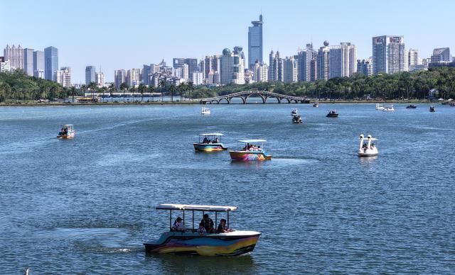 (261008) -- BEIJING, Oct. 8, 2026 (Xinhua) -- A drone photo taken on Oct. 7, 2026 shows tourists taking boat tours at Nanhu park in Nanning City, south China's Guangxi Zhuang Autonomous Region. People across the country enjoyed themselves through various cultural and tourism activities and events during the National Day holiday. (Xinhua/Zhou Hua)