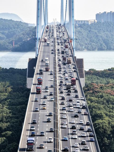 (261008) -- BEIJING, Oct. 8, 2026 (Xinhua) -- An aerial drone photo taken on Oct. 7, 2026 shows vehicles running on a bridge on Beijing-Shanghai Expressway in east China's Jiangsu Province. Return travel flows increased across the country as the National Day holiday concluded on Wednesday. (Photo by Gu Jihong/Xinhua)