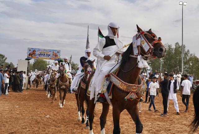 (261008) -- TRIPOLI, Oct. 8, 2026 (Xinhua) -- Riders take part in a traditional equestrian festival in Souq al-Khamis Amsihel, Libya, Oct. 7, 2026. (Photo by Hazem Turkia/Xinhua)