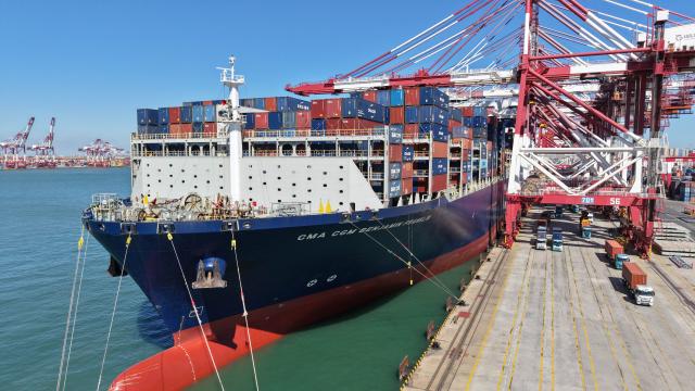 (261008) -- QINGDAO, Oct. 8, 2026 (Xinhua) -- A drone photo taken on Oct. 8, 2026 shows a cargo ship docking at Qingdao Port in Qingdao, east China's Shandong Province. As an international shipping hub in Northeast Asia, Qingdao Port has been expanding its shipping network, adding 16 foreign trade routes so far this year. The port now operates nearly 240 foreign trade routes, connecting over 700 ports in over 180 countries and regions. (Xinhua/Li Ziheng)