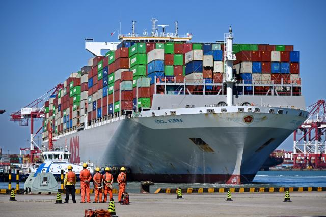 (261008) -- QINGDAO, Oct. 8, 2026 (Xinhua) -- A cargo ship departs from Qingdao Port in Qingdao, east China's Shandong Province, Oct. 8, 2026. As an international shipping hub in Northeast Asia, Qingdao Port has been expanding its shipping network, adding 16 foreign trade routes so far this year. The port now operates nearly 240 foreign trade routes, connecting over 700 ports in over 180 countries and regions. (Xinhua/Li Ziheng)