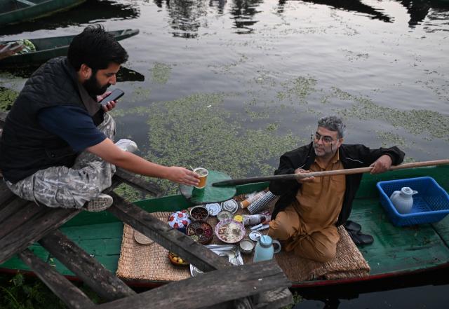 (261008) -- SRINAGAR, Oct. 8, 2026 (Xinhua) -- A tea vendor sells tea from a boat in the early morning on Dal Lake in Srinagar, the summer capital of Indian-controlled Kashmir, Oct. 8, 2026. (Xinhua/Javed Dar)