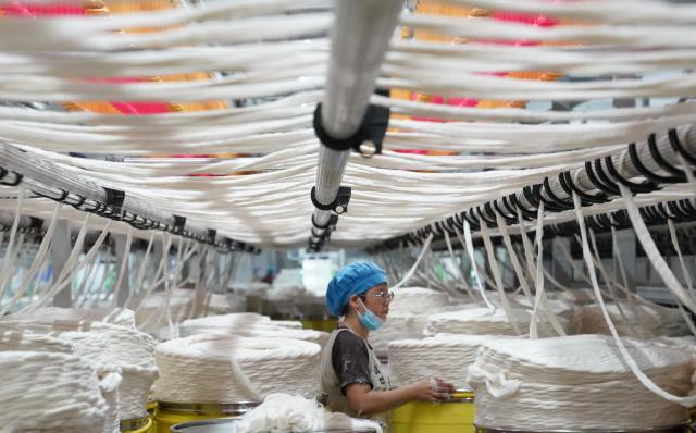 (261008) -- NANCHANG, Oct. 8, 2026 (Xinhua) -- A worker works on a cotton yarn production line at a textile company in Yudu County, east China's Jiangxi Province, Sept. 3, 2026. (Xinhua/Zhou Mi)