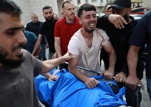 (261008) -- NABLUS, Oct. 8, 2026 (Xinhua) -- Relatives of a Palestinian farmer who was killed in an Israeli attack mourn at Rafidia Hospital in the West Bank city of Nablus, on Oct. 7, 2026. TO GO WITH "Five Palestinians killed in Israeli attacks in Gaza, West Bank " (Photo by Ayman Nobani/Xinhua)