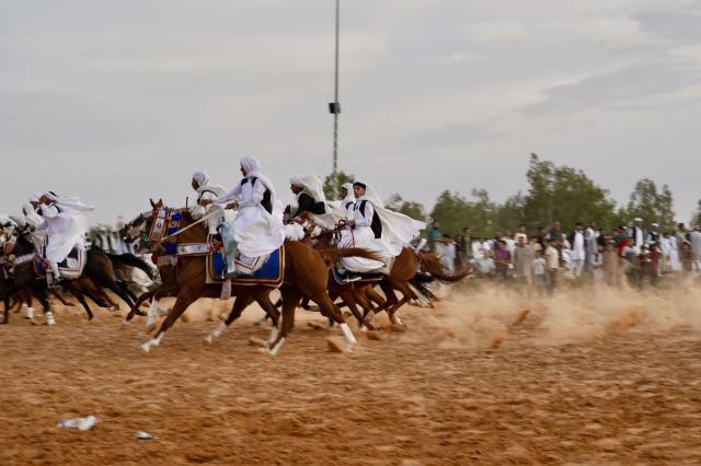 (261009) -- BEIJING, Oct. 9, 2026 (Xinhua) -- Riders take part in a traditional equestrian festival in Souq al-Khamis Amsihel, Libya, Oct. 7, 2026. (Photo by Hazem Turkia/Xinhua)