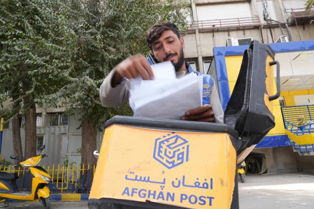 (261009) -- KABUL, Oct. 9, 2026 (Xinhua) -- A postman makes preparation for delivery in Kabul, Afghanistan, Oct. 6, 2026. TO GO WITH "Feature: Afghan Post upgrades services, connects Afghans with world" (Photo by Saifurahman Safi/Xinhua)