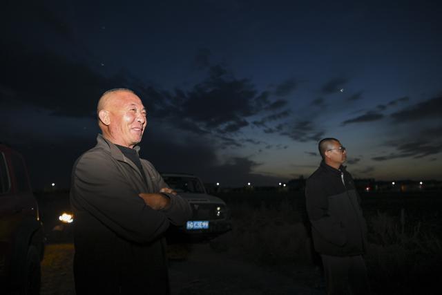 (261009) -- SHAWAN, Oct. 9, 2026 (Xinhua) -- Lu Dewen (R) leads his team in harvesting cotton for other farmers while his father stands at his side in Shawan, northwest China's Xinjiang Uygur Autonomous Region, Sept. 30, 2026.
  As the autumn harvest arrives, cotton fields across Xinjiang turn snow-white. In Shawan, at the foot of the Tianshan Mountains, 35-year-old cotton farmer Lu Dewen is busy managing his cotton-picking team. This year, he planted 1,500 mu (about 100 hectares) of cotton. Since late September, his team's schedule has been filled with harvesting orders from nearby farmers, with some jobs taking them to southern Xinjiang.
  Four years ago, Lu's family bought a cotton picker, allowing them to harvest their own cotton and provide services to other farmers. Lu hired four workers and organized them into two shifts to improve efficiency. As cotton harvesting depends on favorable weather, the team must make the most of clear skies. Lu stays in the fields throughout the harvest to coordinate orders, troubleshoot his machine and manage schedules.
  Lu began farming alongside his father, Lu Gaolin, 10 years ago, learning every stage of cotton production, from sowing and irrigation to harvesting. "Fluctuations in the cotton market are normal, but farming requires steady, hard work," he said.
  Over the years, Lu has witnessed advances in cotton-growing techniques and the wider use of mechanized and intelligent agricultural machinery. His business now extends beyond his own farm to providing harvesting services for other growers. His father has stepped back from daily farm work but still visits the fields during the busy harvest season to check on progress and offer advice.
  Shawan is a major cotton-producing area in northern Xinjiang. According to the local bureau of agriculture and rural affairs, the city planted 1.6457 million mu (about 109,713 hectares) of cotton this year, with mechanized operations accounting for more than 99 percent of the work from sowing to harvesting. (Xinhua/Hu Huhu)