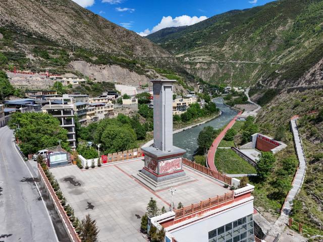 (261009) -- CHENGDU, Oct. 9, 2026 (Xinhua) -- An aerial drone photo taken on June 1, 2026 shows a monument commemorating a join of the Red Army forces in Xiaojin County of Aba Tibetan and Qiang Autonomous Prefecture, southwest China's Sichuan Province. The year 2026 marks the 90th anniversary of the victory of the Long March. Sichuan became closely tied to the Red Army's activities from 1935 to 1936. During the Long March, the Red Army crossed the Jinsha River, formed the Yihai Alliance, fought their way across the Dadu River, seized the Luding Bridge, scaled snow-capped mountains and traversed grasslands, and continued their march northward to victory. (Xinhua/Wang Xi)