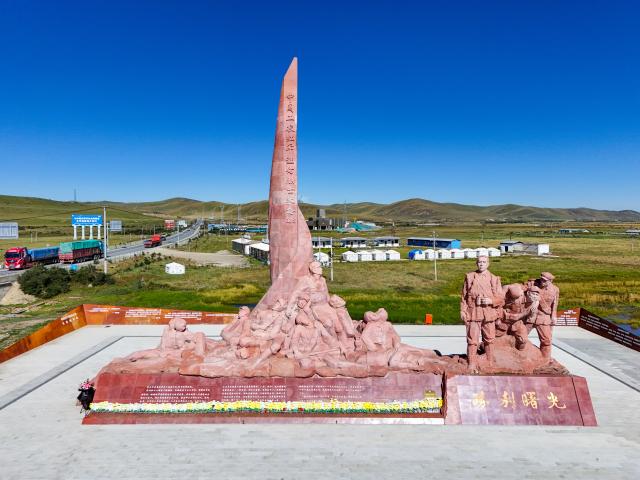 (261009) -- CHENGDU, Oct. 9, 2026 (Xinhua) -- An aerial drone photo taken on Sept. 3, 2026 shows a statue commemorating the Red Army's Long March and a martyrs' monument in Zogie County of southwest China's Sichuan Province. The year 2026 marks the 90th anniversary of the victory of the Long March. Sichuan became closely tied to the Red Army's activities from 1935 to 1936. During the Long March, the Red Army crossed the Jinsha River, formed the Yihai Alliance, fought their way across the Dadu River, seized the Luding Bridge, scaled snow-capped mountains and traversed grasslands, and continued their march northward to victory. (Xinhua/Wang Xi)