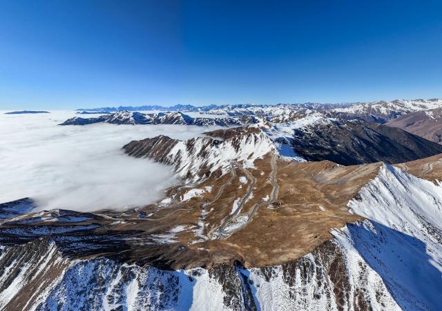 (261009) -- CHENGDU, Oct. 9, 2026 (Xinhua) -- An aerial drone photo taken on Dec. 25, 2024 shows clouds at Jiajin Mountain in southwest China's Sichuan Province. The year 2026 marks the 90th anniversary of the victory of the Long March. Sichuan became closely tied to the Red Army's activities from 1935 to 1936. During the Long March, the Red Army crossed the Jinsha River, formed the Yihai Alliance, fought their way across the Dadu River, seized the Luding Bridge, scaled snow-capped mountains and traversed grasslands, and continued their march northward to victory. (Xinhua/Wang Xi)