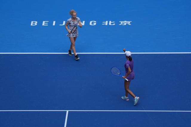 (261009) -- BEIJING, Oct. 9, 2026 (Xinhua) -- Katerina Siniakova (L)/Zhang Shuai celebrate scoring during the women's doubles quarterfinal match between Katerina Siniakova (the Cezch Republic)/Zhang Shuai (China) and Storm Hunter (Australia)/Kristina Mladenovic (France) at 2026 China Open tennis tournament in Beijing, China, Oct. 9, 2026. (Xinhua/Xie Han)