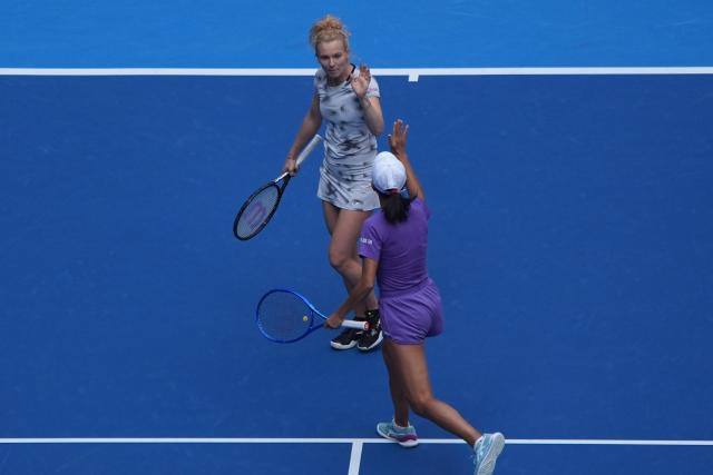 (261009) -- BEIJING, Oct. 9, 2026 (Xinhua) -- Katerina Siniakova (top)/Zhang Shuai celebrate during the women's doubles quarterfinal match between Katerina Siniakova (the Cezch Republic)/Zhang Shuai (China) and Storm Hunter (Australia)/Kristina Mladenovic (France) at 2026 China Open tennis tournament in Beijing, China, Oct. 9, 2026. (Xinhua/Xie Han)