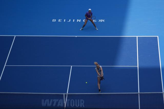 (261009) -- BEIJING, Oct. 9, 2026 (Xinhua) -- Katerina Siniakova (front)/Zhang Shuai compete during the women's doubles quarterfinal match between Katerina Siniakova (the Cezch Republic)/Zhang Shuai (China) and Storm Hunter (Australia)/Kristina Mladenovic (France) at 2026 China Open tennis tournament in Beijing, China, Oct. 9, 2026. (Xinhua/Xie Han)