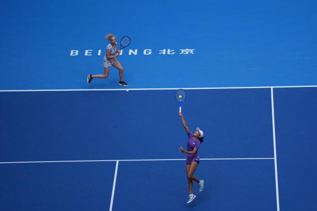 (261009) -- BEIJING, Oct. 9, 2026 (Xinhua) -- Katerina Siniakova/Zhang Shuai (front) compete during the women's doubles quarterfinal match between Katerina Siniakova (the Cezch Republic)/Zhang Shuai (China) and Storm Hunter (Australia)/Kristina Mladenovic (France) at 2026 China Open tennis tournament in Beijing, China, Oct. 9, 2026. (Xinhua/Xie Han)
