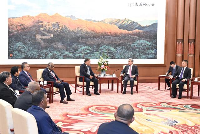 (261009) -- BEIJING, Oct. 9, 2026 (Xinhua) -- Wang Yi, a member of the Political Bureau of the Communist Party of China (CPC) Central Committee and director of the Office of the Foreign Affairs Commission of the CPC Central Committee, meets with a delegation of political leaders from Pacific Island countries led by Tongan Deputy Prime Minister Viliami Uasike Latu in Beijing, capital of China, Oct. 9, 2026. (Xinhua/Tian Yu)