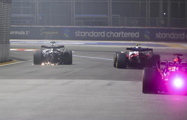 (261009) -- SINGAPORE, Oct. 9, 2026 (Xinhua) -- Cadillac's Mexican driver Sergio Perez (L) is seen driving after crashing during sprint qualifying for the Formula One Singapore Grand Prix at the Marina Bay Street Circuit on Oct. 9, 2026. (Photo by Then Chih Wey/Xinhua)